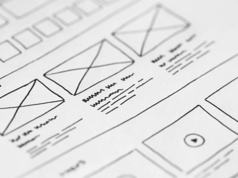 Detailed close-up of a hand-drawn wireframe design on paper for a UX project